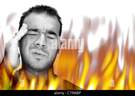 A man experiencing pain and suffering with hot fiery flames burning around him. Stock Photo