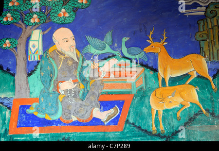 A painting in traditional Tibetan buddhist style shows a benevolent contemplative sage. Stock Photo