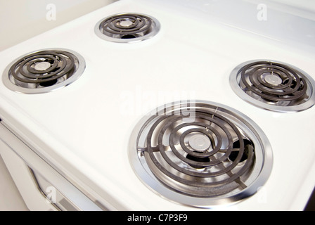 A white electric stove with four burners. Stock Photo