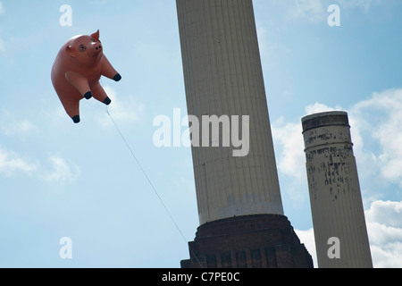 An inflatable pig flies once more over Battersea Power Station as an homage to the famous Pink Floyd album cover from Animals Stock Photo