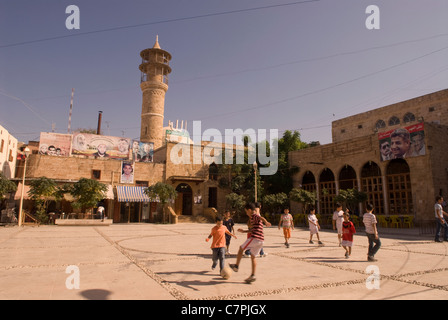 Children playing football in the midst of the Bab al-Saray mosque dating from 1201, Sidon, southern Lebanon. Stock Photo