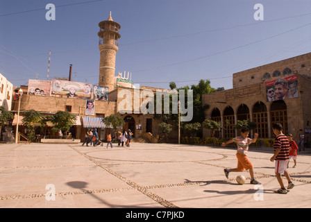 Children playing football in the midst of the Bab al-Saray mosque which dates from 1201, Sidon (Saida), southern Lebanon. Stock Photo