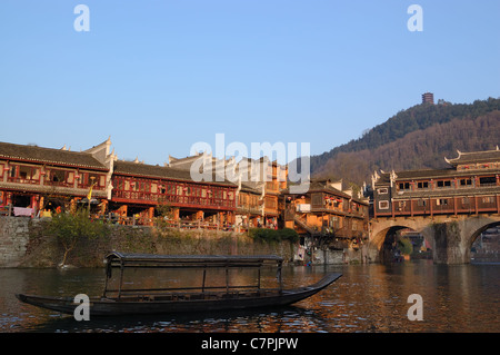 China river landscape with boat and ancient building in Fenghuang county, Hunan province, China Stock Photo