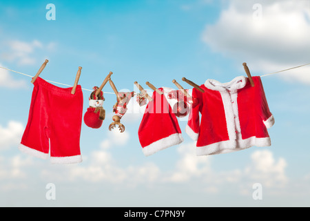 Santa claus laundry hanging on a clothesline in the sky Stock Photo