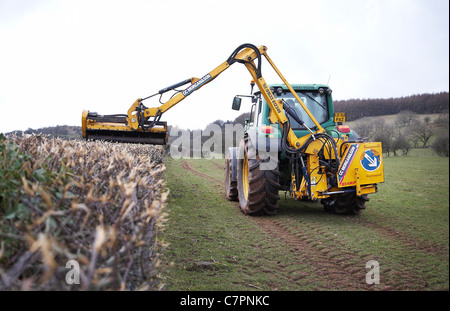 Tractor cutting hedges on farmland in south Wales, UK. Stock Photo