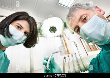 Dentist and assistant working in office Stock Photo