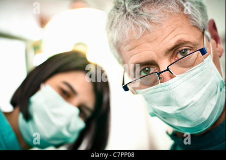 Dentist and assistant working in office Stock Photo