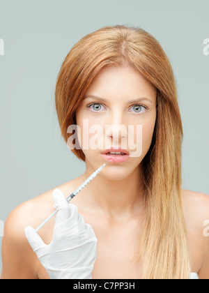 beautiful young woman having colagen injection lips Stock Photo