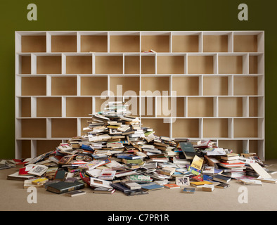 Pile of books by empty shelves hi-res stock photography and images - Alamy