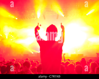 A music fan on someones shoulders at a music festival Stock Photo