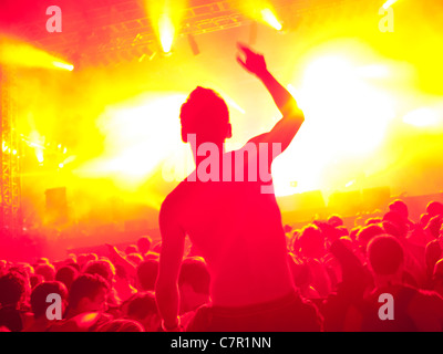 A music fan on someones shoulders at a music festival Stock Photo