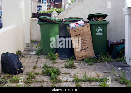 sacks of rubbish and recycling bins in a front garden Stock Photo