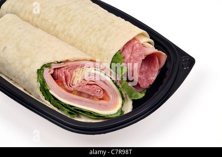 Italian sandwich  wrap cut in half on black plate on white background.  USA. Stock Photo