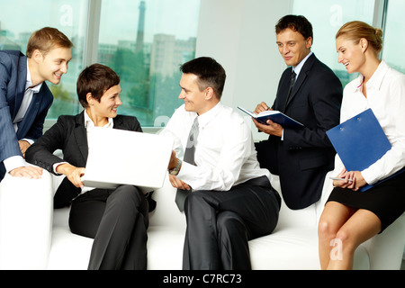 Five business people communicating in office Stock Photo