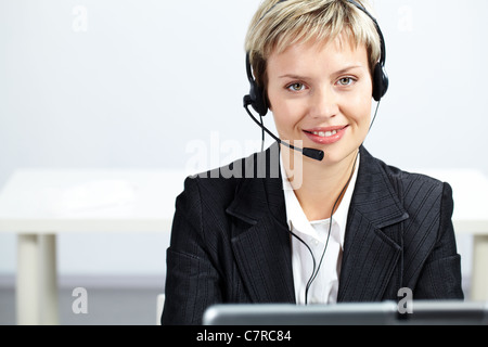 Portrait of pretty blond operator looking at camera and smiling Stock Photo