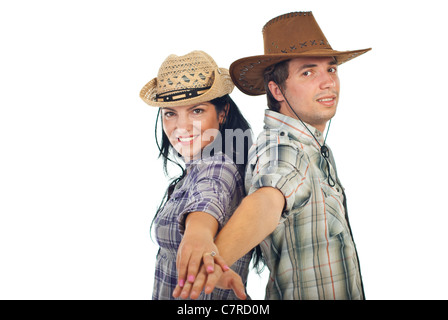 Happy couple in cowboy's hats standing back to back and holding their hands in front of camera isolated on white background Stock Photo
