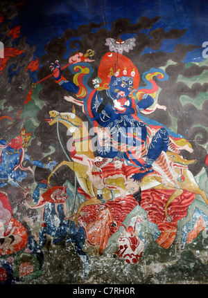 A wall painting of Shri Devi, Palden Lhamo, the Glorious Goddess with her red hair, riding on her three eyed white mule. Stock Photo