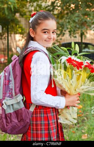 A pretty young girl on her way to school Stock Photo