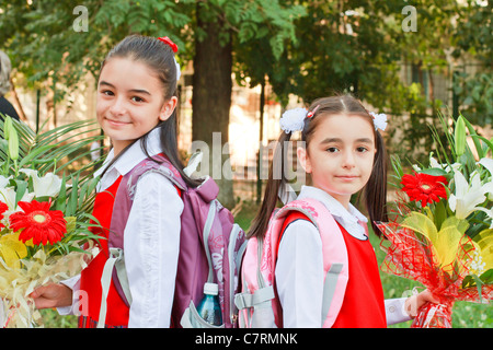 Two pretty young girls on their way to school Stock Photo