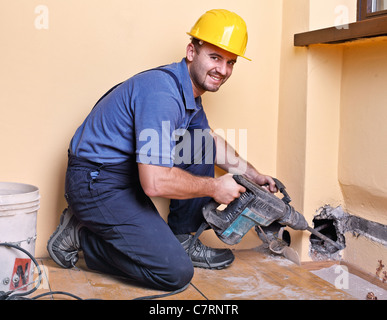caucasian handyman with big drill on duty Stock Photo
