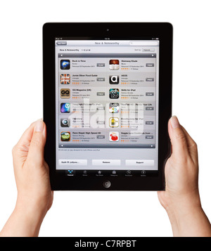 Female hands holding iPad showing Apple App Store software applications available to purchase Stock Photo