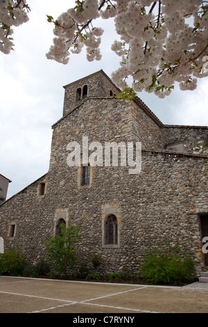 A church with blossom tree in Quillan, near Limoux S Aude, France Stock Photo