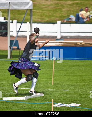 Kilted German athlete throwing the weight for distance at Cowal Highland Gathering, 2011, Dunoon. Stock Photo