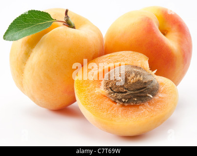Apricots with leaves on a white background. Stock Photo