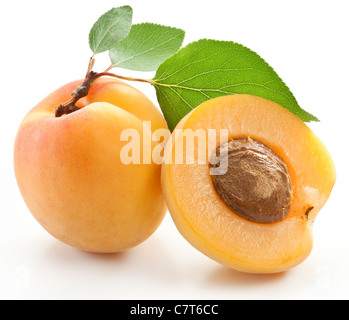 Apricots with leaves on a white background. Stock Photo