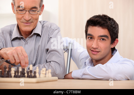 Father and son playing chess Stock Photo