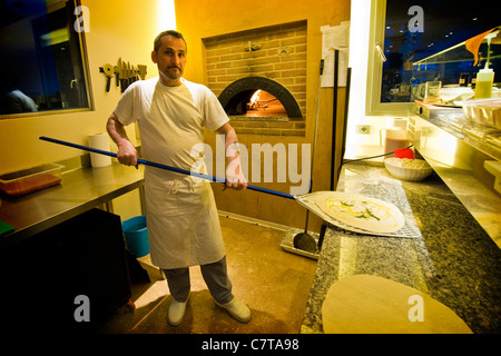 Italy, Umbria, Montecchio, Country house, Pizza chef making pizza Stock Photo