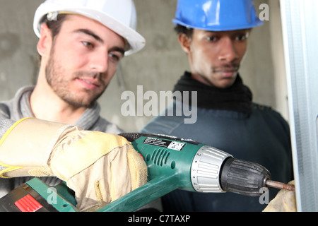 Electricians on construction site Stock Photo