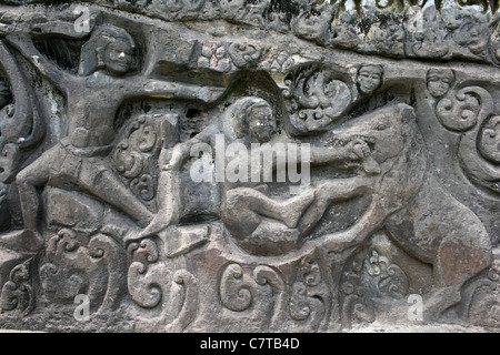 Rock Art Relief Showing Men Hunting Wild Boar at Yeh Pulu, Bali Stock Photo