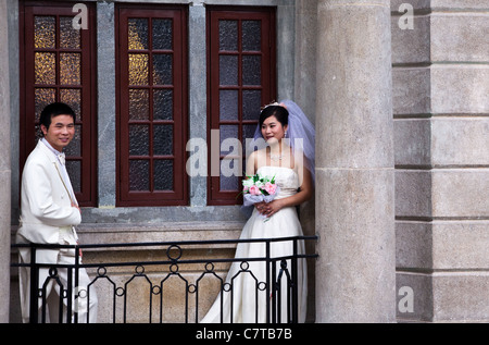 Wedding couple posing for the camera on Shamian Island, Guangzhou, China. Stock Photo