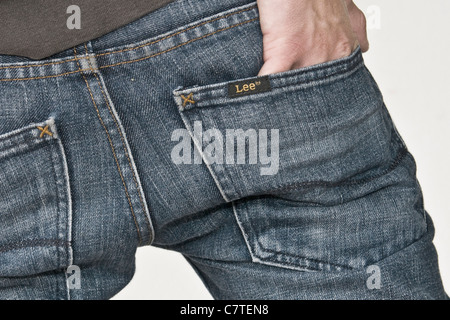Rear view of young man putting hand in pockets of his jeans Stock Photo