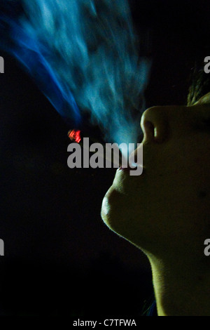 Teen boy smoking joint Stock Photo