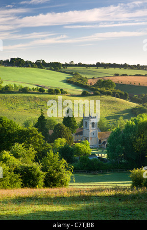 Naunton church, nestled in the beautiful rolling Cotswolds countryside, Gloucestershire, England. Summer (July) 2010. Stock Photo