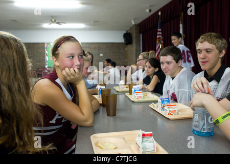 Junior high students in the Paint Creek, TX schools sit and chat in the school's cafeteria for morning announcements. Stock Photo