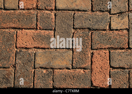 background of red bricks in a herringbone pattern from a walkway Stock Photo