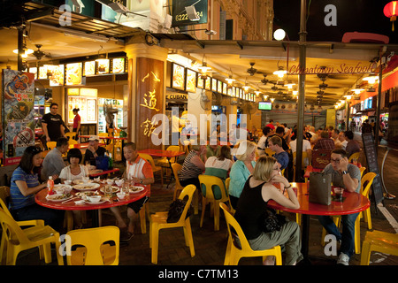 Street scene with people eating at chinese restaurants, Chinatown Singapore Stock Photo