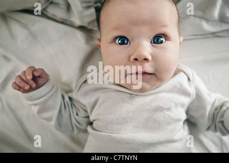 3 Month old Baby Girl on Bed Stock Photo
