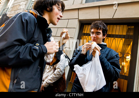 Teenage boys having a snack outdoors Stock Photo