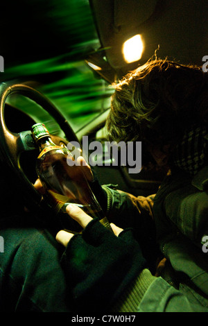 Man with whisky bottle sitting in car Stock Photo