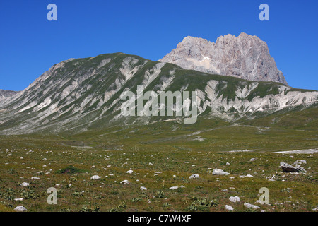 Italy, Abruzzo, Campo Imperatore plain. In the background the Corno Grande Mount, Gran Sasso and Monti della Laga national park Stock Photo