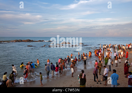 Pilgrims taking holi dip where the Bay of Bengal,Arabian sea and Indian ocean meet. Kanyakumari. Cape Comorin. Tamil Nadu. India Stock Photo