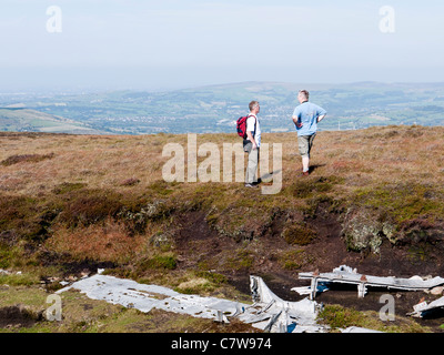 Two men discussing the wreck of a Liberator, Mill Hill, High Peak, Derbyshire, England, UK. Stock Photo