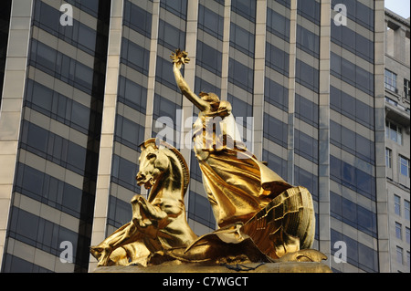 Gold sculpture Columbia Triumphant, seashell chario seahorses, top Maine Monument, front skyscraper, Central Park, New York City Stock Photo