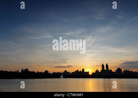 Sunset over buildings of New York City's West Side as seen from the Reservoir in Central Park. Stock Photo