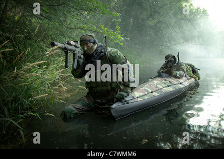 Navy SEALs navigate the waters in a folding kayak during jungle warfare ...