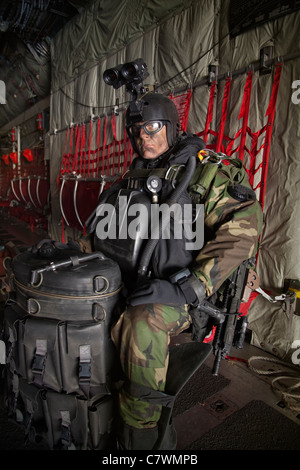 U.S. Navy SEAL combat diver prepares for HALO jump operations from a C ...